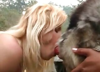 Lovely blonde fuckdoll is performing a blowjob on a dog